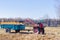 Small mini red tractor stands on a farm yard. Springtime and harvest concept.