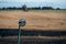 Small mirror mounted next to a rural road crossing the fields in southern Sweden