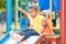 Small mixed race girl using a slide at a playground