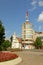 Small modest evangelic church next to a cylindrical modern apartment building in Alba Iulia, Romania