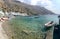 Small moored fishing boats in blue lagoon of Crete island.