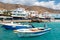 Small moored fishing boats in blue lagoon of Crete island.