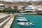 Small moored fishing boats in blue lagoon of Crete island.