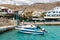 Small moored fishing boats in blue lagoon of Crete island.