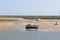 Small motor boat beached at low tide in Wells-next-the-Sea