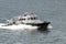 Small motor boat speeds by sea