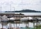 Small motor boats moored on wooden poles of the pier of a small port in Lake Trasimeno Umbria, Italy