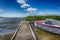 Small motorboat moored alongside a wooden jetty