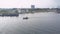 Small motorboat sails by embankment quays with mooring boats