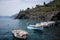 Small motorboats are moored in bay of Cinque Terre National Park on the Italian Riviera.