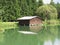Small mountain lake with house over water and forest background . Fie allo sciliar, South Tyrol, Italy