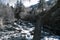 A small mountain stream flows among stones in forest