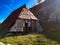 Small mountain village on a beautiful autumn fall day, closeup of old traditional cabin hut house surrounded by natural landscape