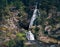 small mountain waterfalls inside forest. Scenery landsape. Desaturated effect