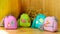 Small multi-colored children`s handbags-key chains wallets with pictures and names of fruit.