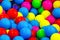 Small multi colored plastic baby balls, background texture