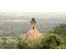 Small Nandi bull temple and statue on top of a rock at mountain peak