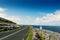 Small narrow asphalt road by Atlantic ocean, Black Head Lighthouse area, Burren, Ireland.