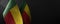 Small national flags of the Benin on a dark background