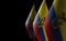 Small national flags of the Ecuador on a black background