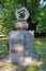 Small neat monument with an inscription and ornament standing on a green meadow