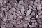 Small non-uniform stones burgundy-gray color, background
