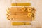 A small number of different types of pasta on a wooden background, fettuccine on a cutting Board made of bamboo