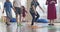 Small nursery school children with female teacher on floor indoors in classroom, doing exercise. Jumping over hula hoop