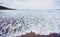 Small ocean sea waves on sandy beach in calm weather.