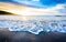 Small ocean sea waves on sandy beach with sunrise sunset.