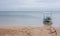 A small old boat with an anchor at a beach in Tonga