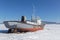 Small old ship caught in the ice of Khvosgol Lake