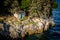 Small old stone lodge on a rocky shore