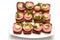 Small open sandwiches on white plate