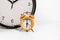 Small orange analog clock with big clock concept time passing faster