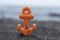 Small orange anchor beach toy
