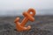 Small orange anchor beach toy