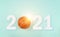 Small orange ball for basketball sport game on blue background with text 2021 and sunshine