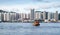 Small orange passenger ferry goes at Hong Kong bay