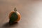 Small organic tangerine with leaves on wood table
