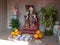 Small ornamental buddist shrine with offerings of fruit and veg