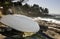 Small overturned rowboat stored on rocky shoreline, Gabriola Island, BC, Canada.