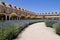 A small park with lavender plants and historical buildings in Aranjuez, Spain