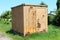 Small partially rusted metal shipping container abandoned on old railway station