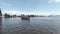 Small passenger boat crosses the Chao Phraya river