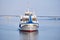 Small passenger ship on the river and road bridge in the morning haze in the background