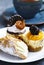 Small pastries. Sicilian cannoli, mango cheesecake and classic c