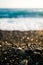 Small pebble on the black beach with beautiful evening light - with ideal bokeh background