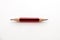 A small pencil, sharpened at both ends, on a white background