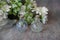 Small perfume bottles with flowers at the bacground